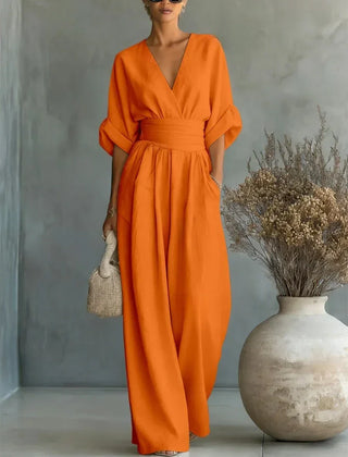 Orange V-neck high-waisted jumpsuit with gathered waist and loose wide-leg silhouette