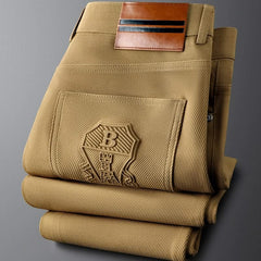 Khaki premium pants close-up of back pockets with embossed logo patch