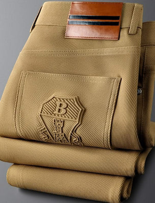 Khaki premium pants close-up of back pockets with embossed logo patch