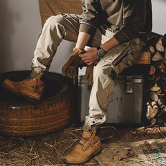 Khaki utility trousers with drawstring waist, cargo pockets, and cuff straps