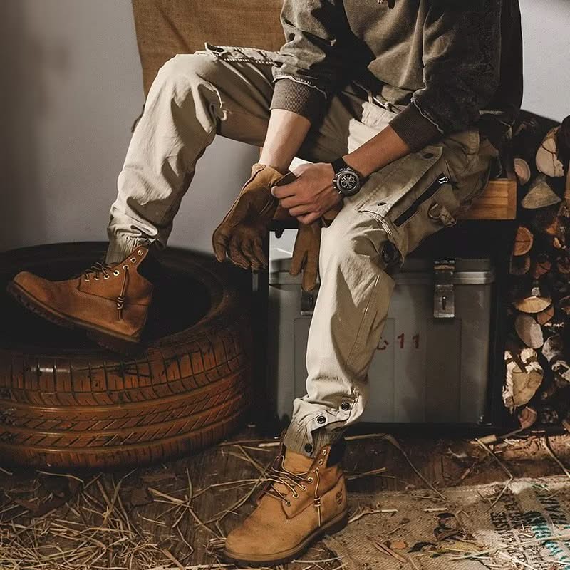 Khaki utility trousers with drawstring waist, cargo pockets, and cuff straps