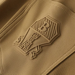 Khaki premium pants fabric close-up with embossed back pocket logo