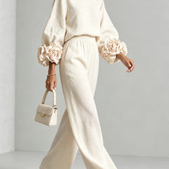 White two-piece set: long-sleeve blouse and wide-leg pants with floral puff cuff sleeves