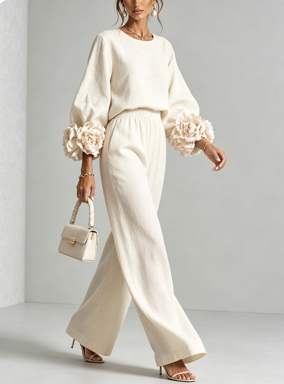 White two-piece set: long-sleeve blouse and wide-leg pants with floral puff cuff sleeves