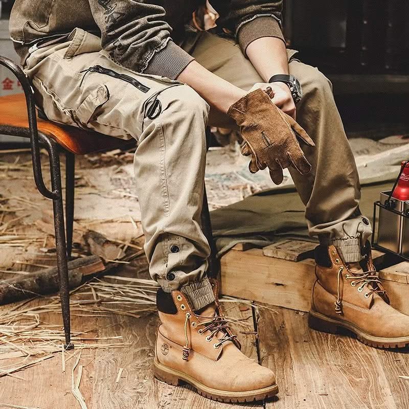 Khaki utility trousers with cargo pockets, knee seams, and cuff fastening