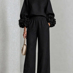 Black two-piece set: long-sleeve blouse and wide-leg pants with floral puff cuff sleeves
