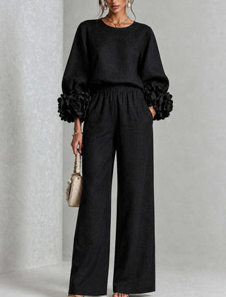 Black two-piece set: long-sleeve blouse and wide-leg pants with floral puff cuff sleeves