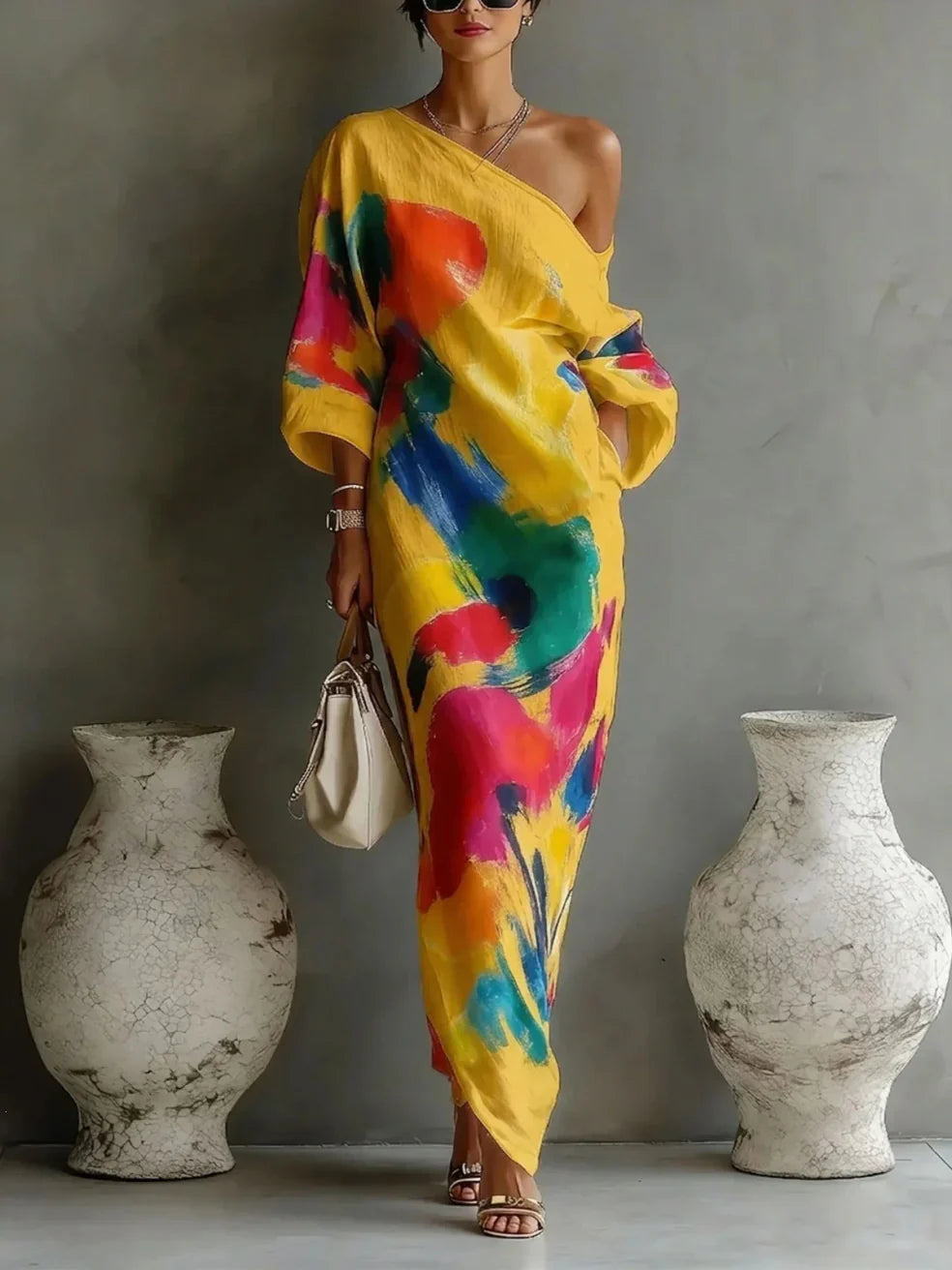 One-shoulder maxi dress in yellow with multicolor abstract paint pattern, draped sleeves