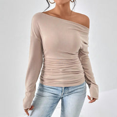 Apricot long sleeve asymmetrical shoulder top with gathered ruched midsection.