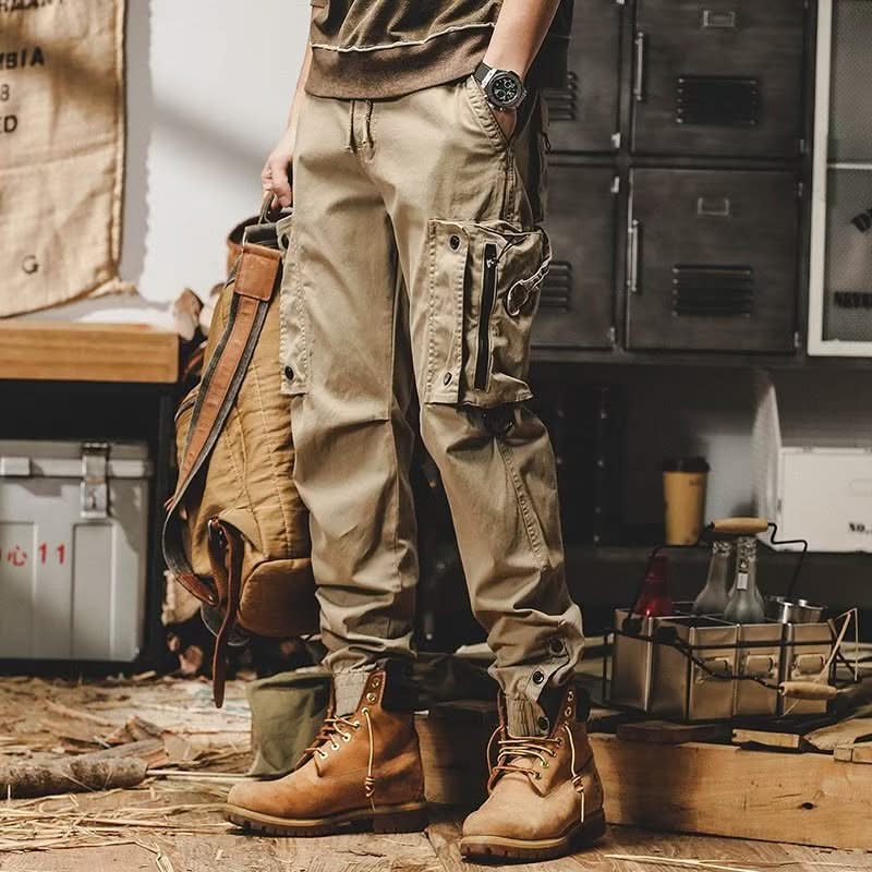 Khaki utility trousers with multiple cargo pockets and button-flap thigh panels