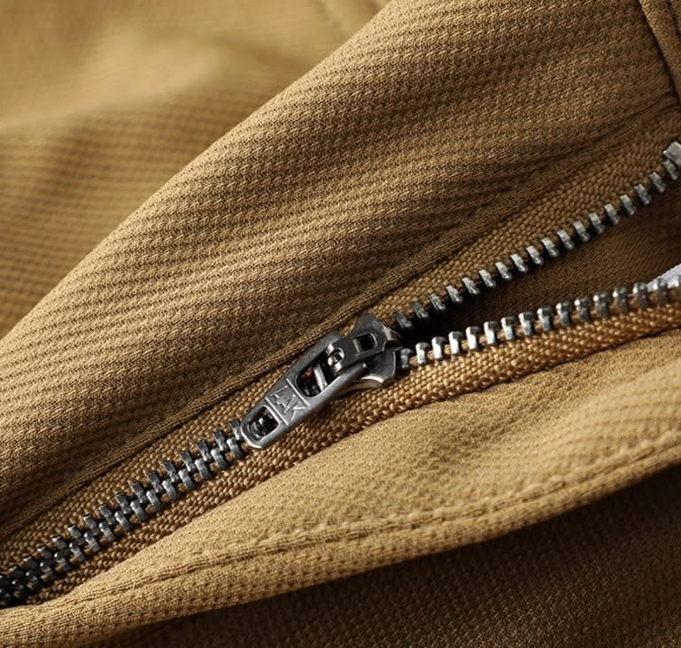 Khaki premium pants close-up of zip fly and textured waistband fabric
