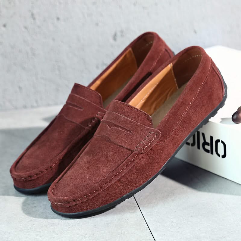 Suede loafers in maroon with moc stitching, strap detail, and tan interior