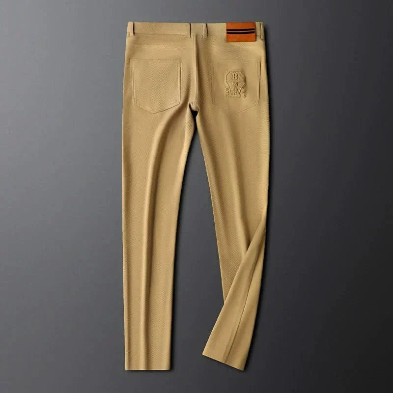 Khaki premium pants front view on hanger with side pockets and logo on right