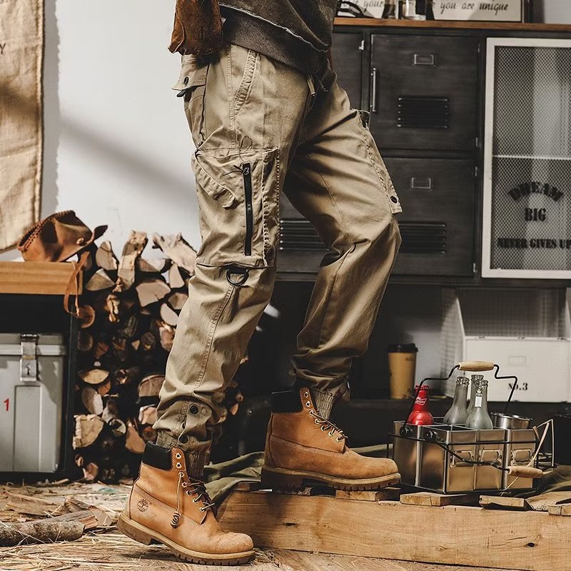 Khaki utility trousers with leg cargo pockets and adjustable cuff tabs
