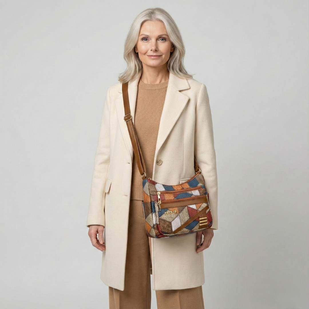 Patchwork leather shoulder bag worn crossbody with dual front zippers and strap