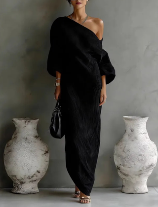 Black one-shoulder maxi dress with draped wrap bodice and long column skirt