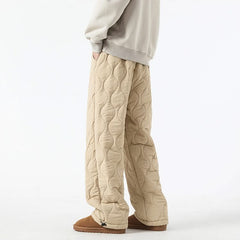 Beige quilted pants with raised oval pattern and ankle-length relaxed fit.