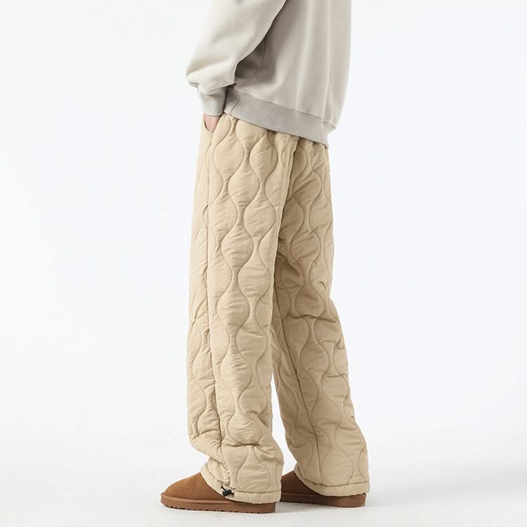 Beige quilted pants with raised oval pattern and ankle-length relaxed fit.