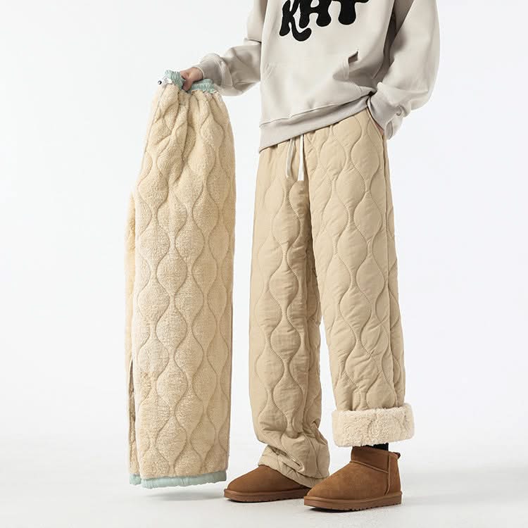 Beige quilted pants with raised oval pattern and ankle cuffs, drawstring waist.