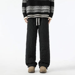 Black quilted jogger pants with drawstring waist and sherpa-fleece cuff hems