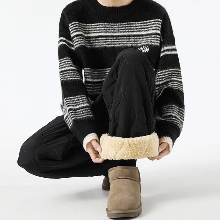 Black quilted pants with raised oval pattern and sherpa-lined cuffs, drawstring waist.