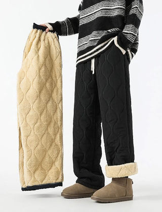 Black quilted drawstring pants with elastic waist and sherpa-lined cuffs.