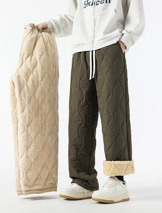 Olive quilted pants with elastic waist, drawstring, and sherpa-lined cuffs.