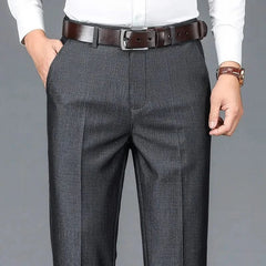 Charcoal dress trousers with belt loops, zip fly, and vertical crease seam.