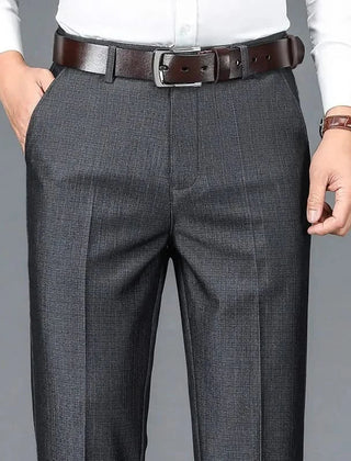 Charcoal dress trousers with belt loops, zip fly, and vertical crease seam.