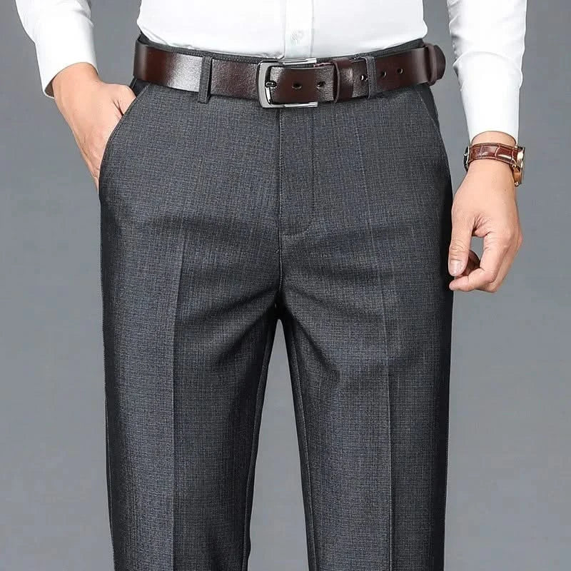 Charcoal dress trousers with belt loops, zip fly, and vertical crease seam.