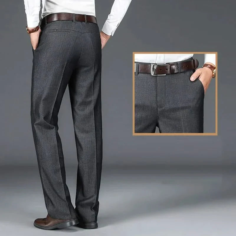 Charcoal dress trousers on model, showing belt loops and straight-leg cut.