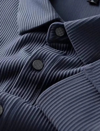 Blue business shirt close-up, ribbed texture with dark buttons along the placket