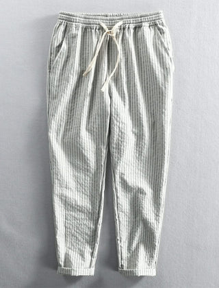 Light striped linen pants in white and gray with elastic waistband and drawstring