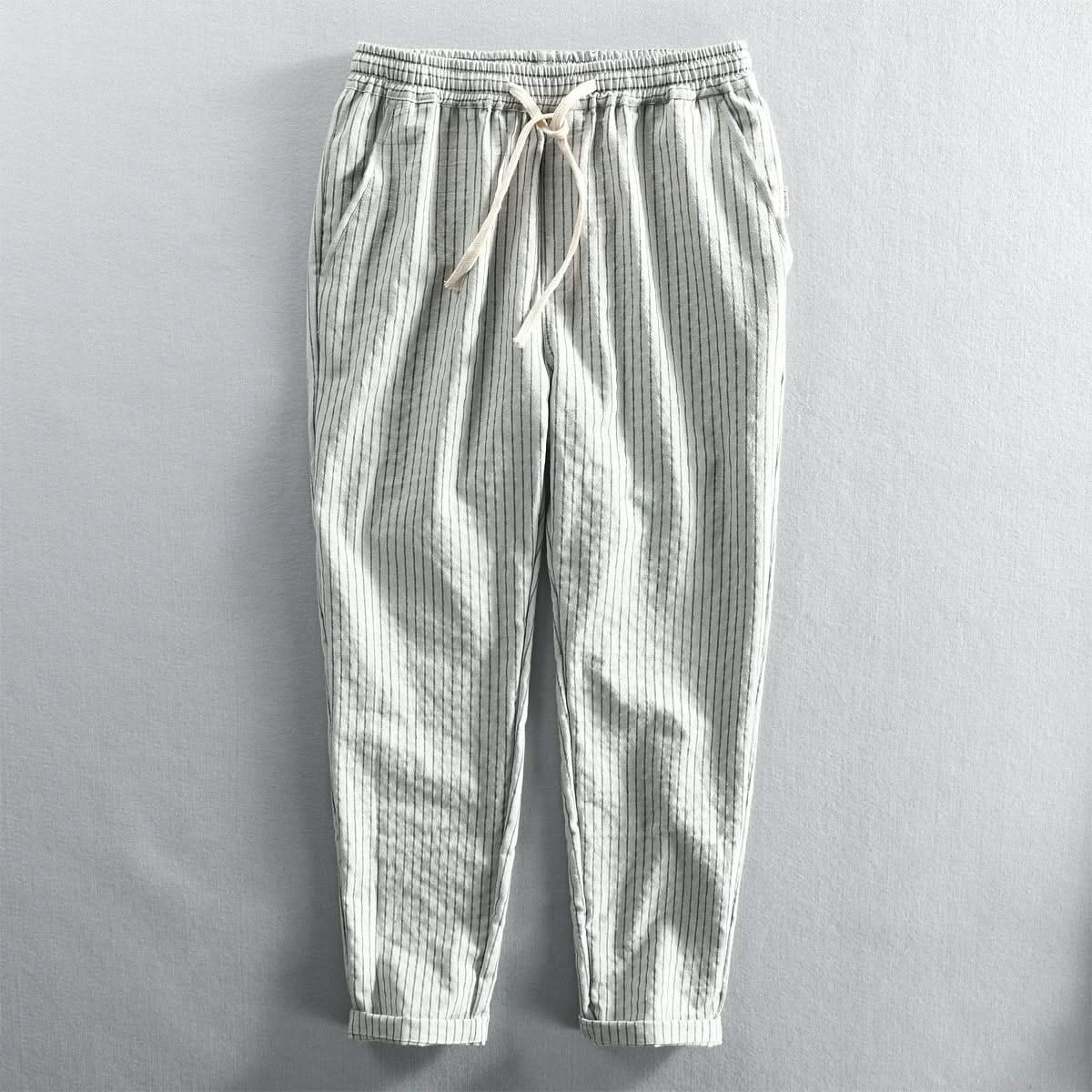Light striped linen pants in white and gray with elastic waistband and drawstring