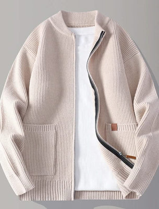 Beige rib knit zip-up jacket with stand collar, front pockets, and tan logo patch