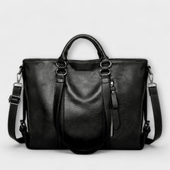 Black large leather handbag with double top handles, shoulder straps, and zip pocket