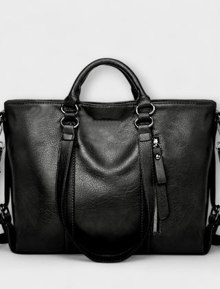Black large leather handbag with double top handles, shoulder straps, and zip pocket