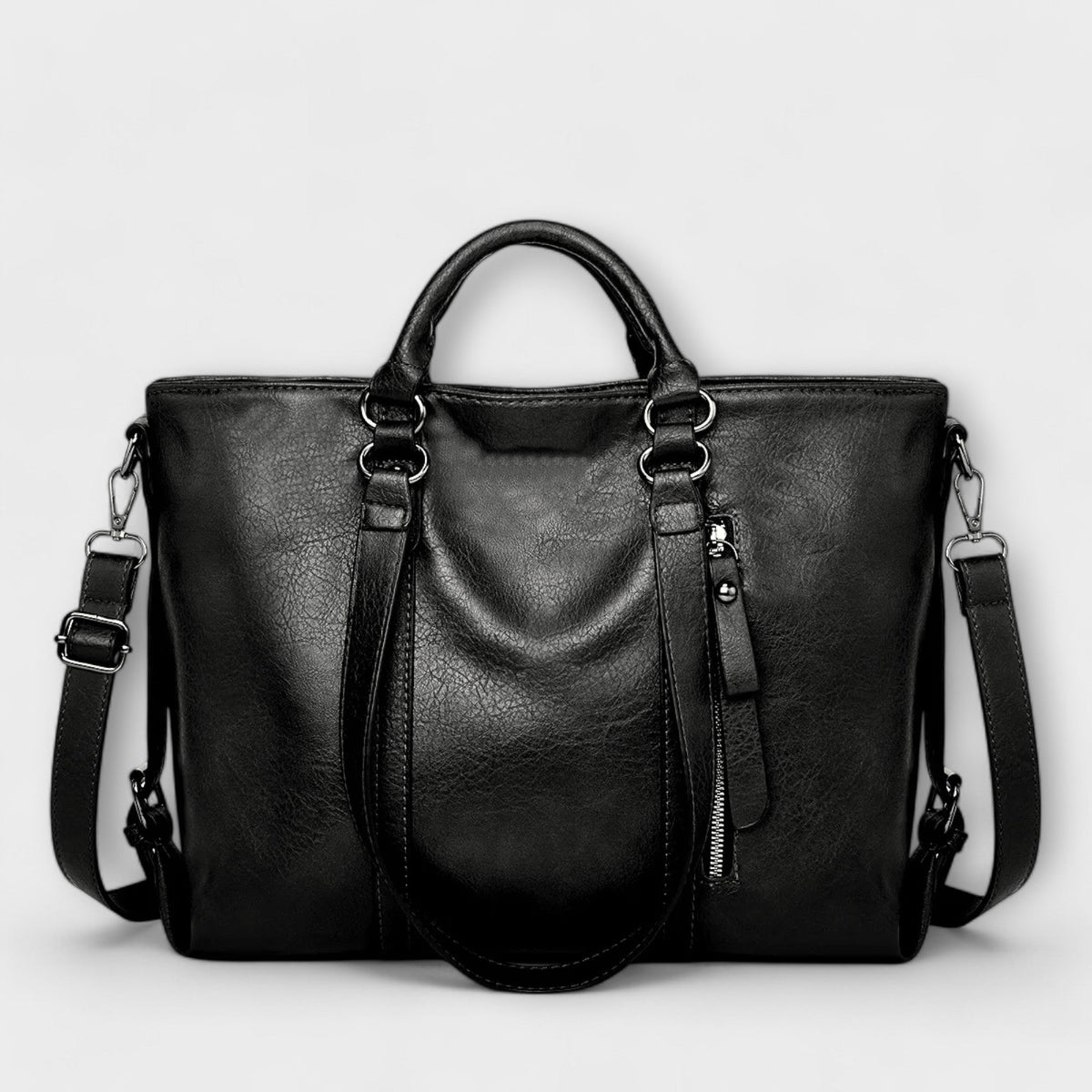 Black large leather handbag with double top handles, shoulder straps, and zip pocket