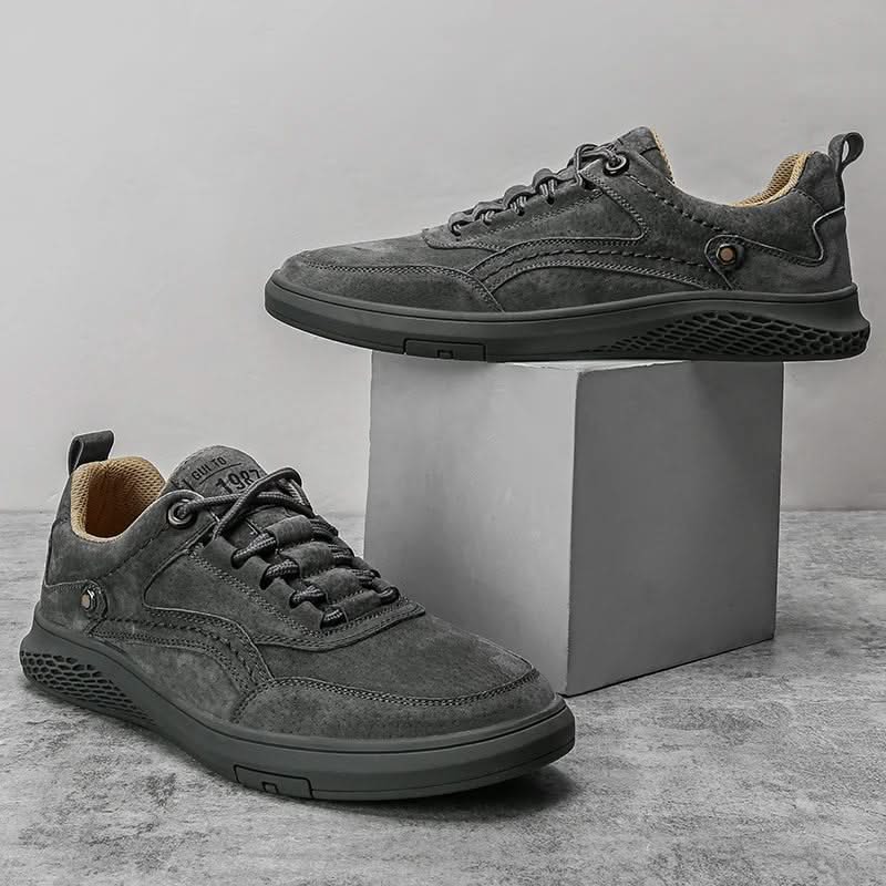 Grey suede lace-up sneakers pair with textured tread sole and padded collar