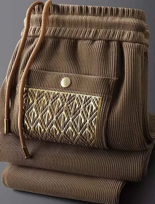 Tan/brown ribbed cotton pants with elastic waist and drawstring, front patterned pocket