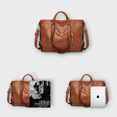 Brown leather handbag with top handles and shoulder straps