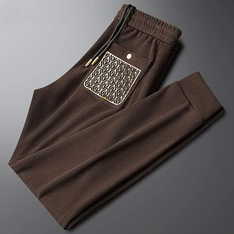 Dark brown ribbed cotton pants with elastic waist and drawstring, patterned front pocket