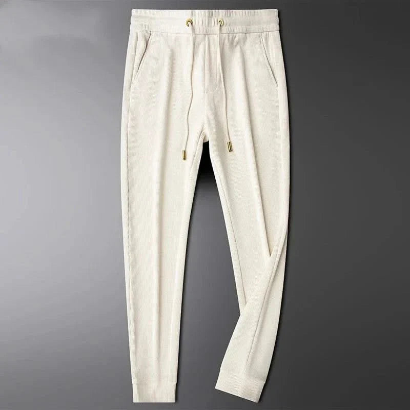 Cream/white cotton pants with elastic waistband and drawstring, front pocket
