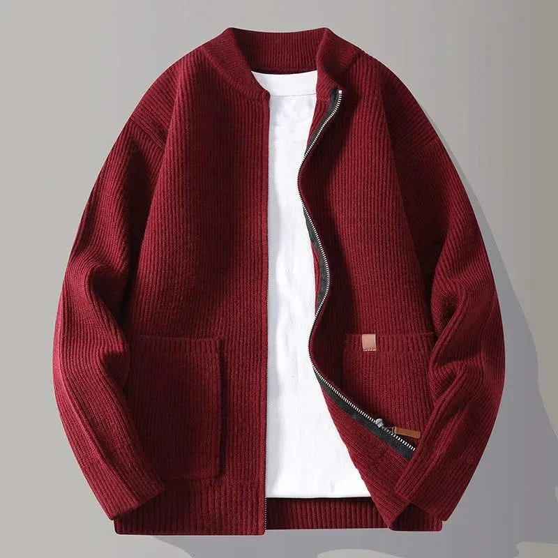 Red rib knit zip-up jacket with stand collar, front pockets, and tan logo patch