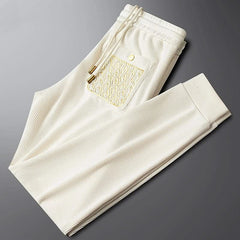 Off-white ribbed cotton pants with elastic waistband, side pocket and drawstring