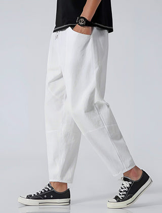 White cropped cotton pants with elastic waist and slanted side pockets