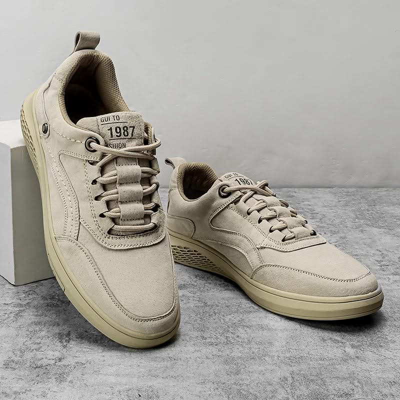 Cream suede lace-up sneakers with contrasting stitching and padded ankle collar