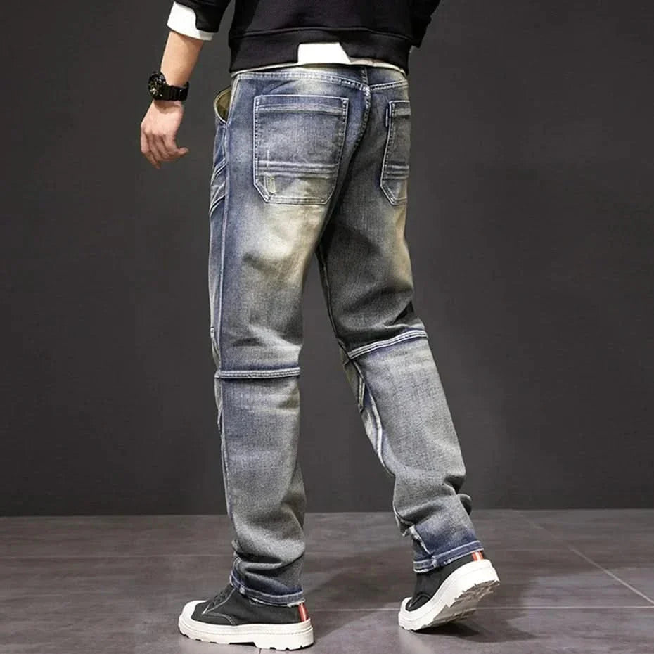 Men's straight jeans, dark blue wash with front zip fly, flap pockets, and tapered cuffs