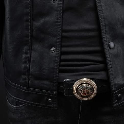 Black leather jacket close-up of snaps, shirt front, and decorative belt buckle.