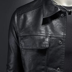 Black leather jacket chest detail with flap pocket and snap buttons.